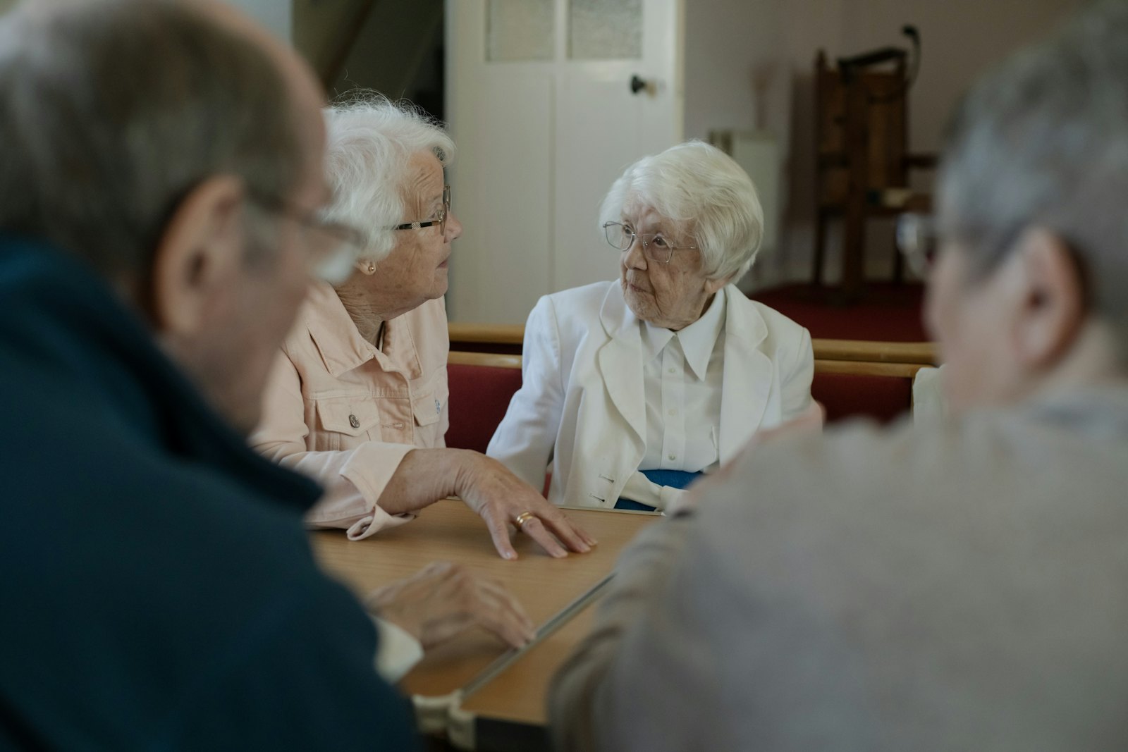 Friends chatting around a table at a meeting